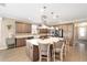 Bright kitchen boasting ample cabinets, stainless steel appliances, a large island with bar seating, and modern lighting at 5111 Nw 35Th Pl, Ocala, FL 34482