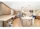 Modern kitchen featuring custom cabinets, stainless steel appliances, a spacious island, and an open-concept design at 5111 Nw 35Th Pl, Ocala, FL 34482