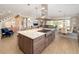 Bright, open-concept kitchen featuring a large island with a cooktop, stainless steel hood, and pendant lighting at 5111 Nw 35Th Pl, Ocala, FL 34482