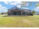 Spacious screened-in lanai with view of the fenced yard at 5111 Nw 35Th Pl, Ocala, FL 34482