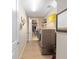 Functional laundry room with modern washer and dryer, storage shelves, and a walk-in closet at 5111 Nw 35Th Pl, Ocala, FL 34482