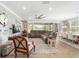 Spacious living room with stone accent wall, lots of windows, neutral paint and plenty of seating at 5111 Nw 35Th Pl, Ocala, FL 34482