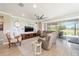 Stylish living room with a stone accent wall, large television, and comfortable seating overlooking the patio at 5111 Nw 35Th Pl, Ocala, FL 34482