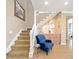 Staircase featuring a small bar area with wooden cabinets and a blue upholstered armchair at 5111 Nw 35Th Pl, Ocala, FL 34482