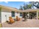 Charming back patio with brick pavers, seating area, and view of the screened sunroom at 530 Nw 113Th Cir, Ocala, FL 34482