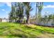 Lush green backyard with a white fence and mature trees providing privacy at 530 Nw 113Th Cir, Ocala, FL 34482