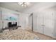 Bedroom featuring wood floors, a white ceiling fan and double door closets for ample storage at 530 Nw 113Th Cir, Ocala, FL 34482