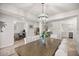 Bright dining room featuring a wood table with white upholstered chairs and decorative light fixture at 530 Nw 113Th Cir, Ocala, FL 34482