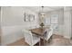 Elegant dining room with wainscoting, stylish mirror, and a modern chandelier at 530 Nw 113Th Cir, Ocala, FL 34482