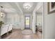 Bright foyer with hardwood floors, stylish rug, and decorative lighting at 530 Nw 113Th Cir, Ocala, FL 34482