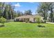 Charming single-story home featuring a well-maintained lawn, mature trees, and inviting front porch at 530 Nw 113Th Cir, Ocala, FL 34482