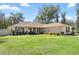 Inviting one-story home features a well-manicured lawn and charming curb appeal with shuttered windows at 530 Nw 113Th Cir, Ocala, FL 34482