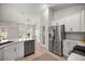 Modern kitchen featuring stainless steel appliances and sleek white cabinetry at 530 Nw 113Th Cir, Ocala, FL 34482