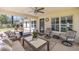 Relaxing screened lanai featuring stylish seating, a ceiling fan, and serene outdoor views at 530 Nw 113Th Cir, Ocala, FL 34482