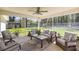 Screened lanai with comfortable seating offers an outdoor retreat with a beautiful backyard view at 530 Nw 113Th Cir, Ocala, FL 34482