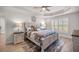 Comfortable bedroom features tray ceilings, a stylish bed, and natural light from shuttered windows at 530 Nw 113Th Cir, Ocala, FL 34482