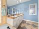 Light-filled bathroom features dual sinks, a granite countertop vanity, and modern fixtures at 5725 Ne 31St Ter, Ocala, FL 34479