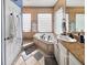 Beautiful bathroom with a soaking tub, shower, and granite countertops, all brightly lit at 5725 Ne 31St Ter, Ocala, FL 34479
