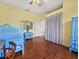 Charming bedroom with blue accents, wood floors, and ample natural light at 5725 Ne 31St Ter, Ocala, FL 34479
