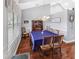 Cozy dining room featuring hardwood floors, a charming light fixture, and a view to the outside at 5725 Ne 31St Ter, Ocala, FL 34479
