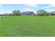 Expansive front lawn leading up to a charming home with mature trees and a serene setting at 5725 Ne 31St Ter, Ocala, FL 34479