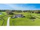 Stunning aerial view of a beautiful home with a large front yard surrounded by wooden fences on a sunny day at 5725 Ne 31St Ter, Ocala, FL 34479
