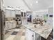 Gorgeous kitchen features a large island with granite countertops, stainless steel appliances, and unique tile flooring at 5725 Ne 31St Ter, Ocala, FL 34479