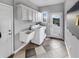 Functional laundry room with a utility sink, ample storage, and natural light at 5725 Ne 31St Ter, Ocala, FL 34479