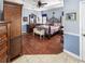 The expansive main bedroom boasts hardwood floors and an elegant wrought iron bed frame and tray ceiling at 5725 Ne 31St Ter, Ocala, FL 34479