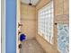 Shower featuring neutral tiling and a glass block window at 5725 Ne 31St Ter, Ocala, FL 34479