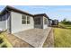 A paved back patio extends from the house and screened in porch to overlook the backyard at 5870 Sw 93Rd Cir, Ocala, FL 34481