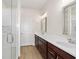 Bright bathroom features dual sink vanity, and glass enclosed shower with decorative tile at 5870 Sw 93Rd Cir, Ocala, FL 34481