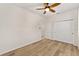 Bedroom featuring hardwood flooring, ceiling fan, and closet space at 5870 Sw 93Rd Cir, Ocala, FL 34481