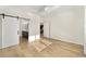 Bright bedroom with a sliding barn door, hardwood floors, and en-suite bathroom at 5870 Sw 93Rd Cir, Ocala, FL 34481