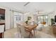 Tastefully decorated dining area with a modern chandelier, dining table set, and open floor plan at 5870 Sw 93Rd Cir, Ocala, FL 34481