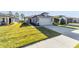 Charming single-Gathering home featuring a well-manicured lawn, a spacious driveway, and inviting curb appeal at 5870 Sw 93Rd Cir, Ocala, FL 34481