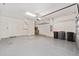 Spacious garage with durable epoxy floor, storage racks, and ample room for vehicles and projects at 5870 Sw 93Rd Cir, Ocala, FL 34481