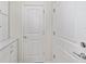 Bright hallway featuring fresh white walls, stylish doors, and convenient built-in cabinets with marble countertop at 5870 Sw 93Rd Cir, Ocala, FL 34481