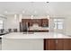 Well-lit kitchen features stainless steel appliances, dark wood cabinets, and island with a sink at 5870 Sw 93Rd Cir, Ocala, FL 34481