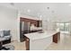 Modern kitchen with stainless steel appliances, dark wood cabinets, and large island with sink at 5870 Sw 93Rd Cir, Ocala, FL 34481