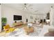 Comfortable living room with modern furniture, a large TV, and an open floor plan at 5870 Sw 93Rd Cir, Ocala, FL 34481
