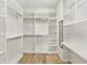 Spacious walk-in closet with custom shelving and a convenient dressing area at 5870 Sw 93Rd Cir, Ocala, FL 34481