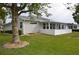 Backyard view of a home with green grass, a privacy fence, and a covered patio at 6548 Sw 84Th Place Rd, Ocala, FL 34476