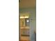 Bathroom featuring a sink, mirror, and a glimpse of another room through a doorway at 6548 Sw 84Th Place Rd, Ocala, FL 34476