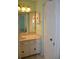 Bathroom featuring a sink, mirror, and a doorway leading to another room at 6548 Sw 84Th Place Rd, Ocala, FL 34476