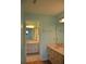 Well-lit bathroom featuring double sinks, a mirror, and a doorway leading to another room at 6548 Sw 84Th Place Rd, Ocala, FL 34476