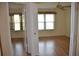 Bright bedroom with wood flooring and a ceiling fan, illuminated by natural light through two windows at 6548 Sw 84Th Place Rd, Ocala, FL 34476