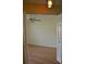 An open bedroom has wood flooring and a ceiling fan, with open doors and a decorative light at 6548 Sw 84Th Place Rd, Ocala, FL 34476