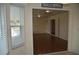 Bright bonus room showcasing wood floors, ceiling fan, and view to an adjacent room at 6548 Sw 84Th Place Rd, Ocala, FL 34476