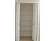 Spacious closet featuring folding doors and multiple wire shelves for optimal storage organization at 6548 Sw 84Th Place Rd, Ocala, FL 34476